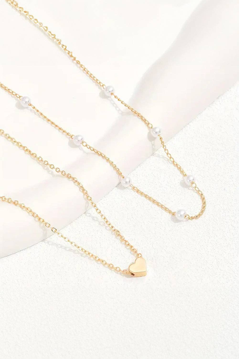 Gold Layered Necklace with Heart Pendant and Pearl Accents