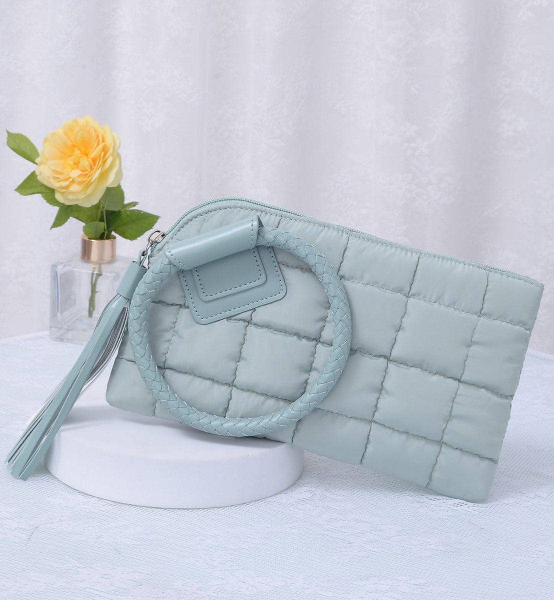 Sage quilted handbag with circular handle 