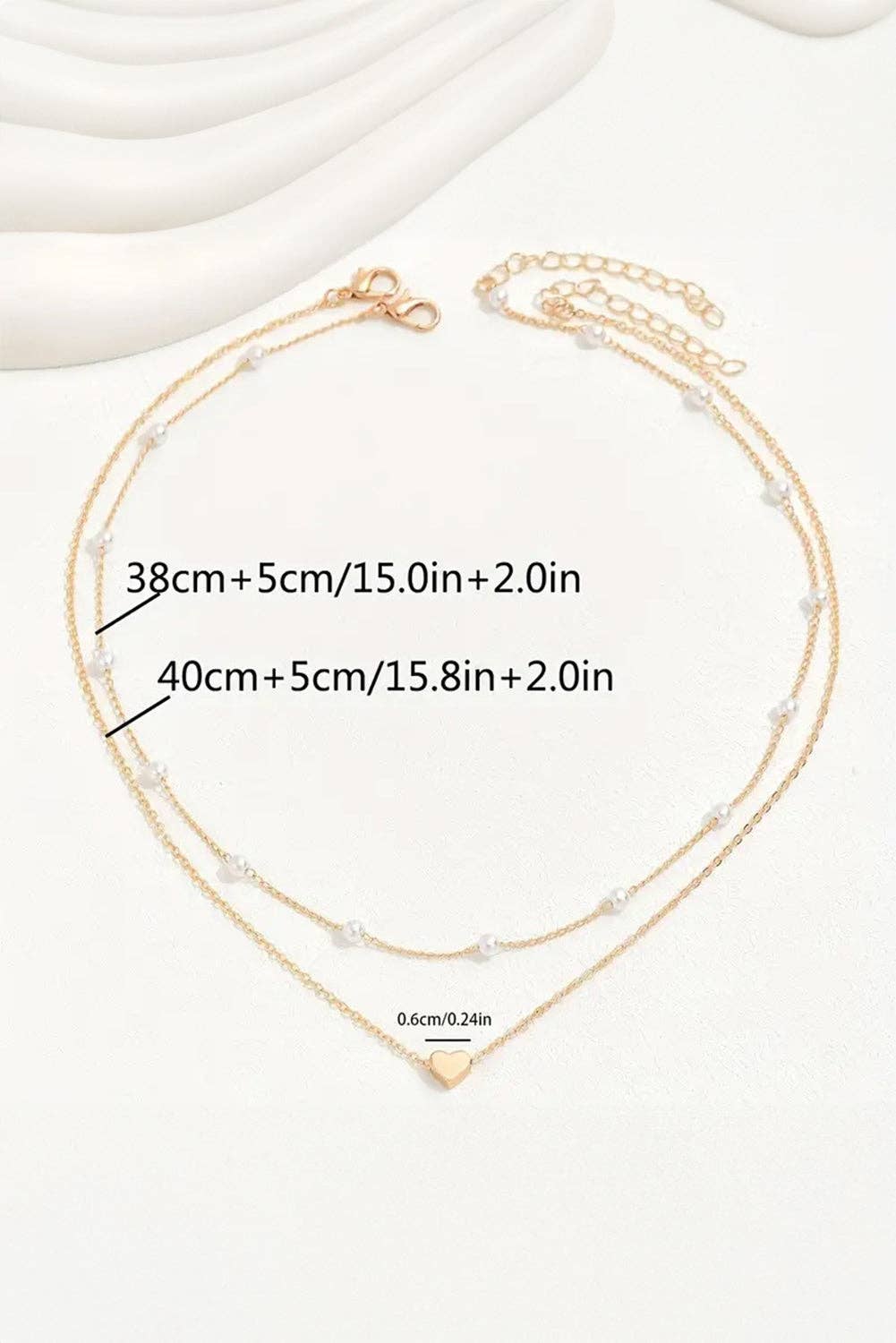 Gold Layered Necklace with Heart Pendant and Pearl Accents
